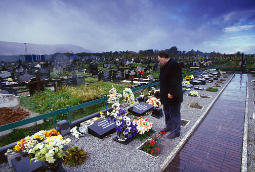 Mourner in Milltown Cemetery in Belfast