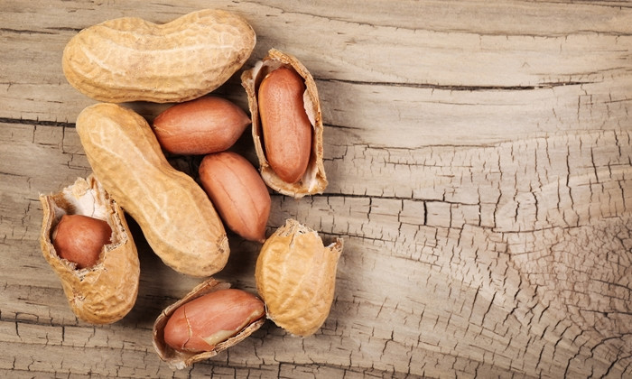Peanuts in shells on wooden  background